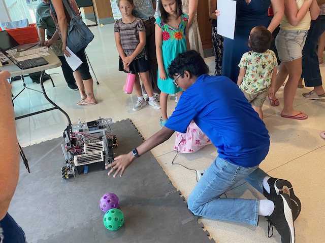 Techs Mechs member demonstrating the robot at the Texas 4-H Open House